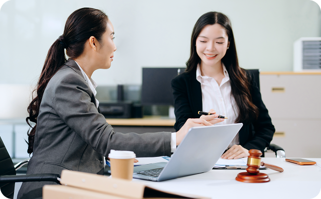 Two professionals discussing documents in an office.
