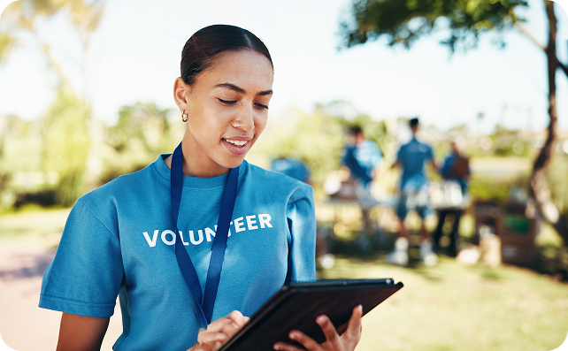 Volunteer using a tablet during a community event.